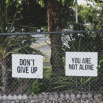 photo of house displaying encouraging signs in yard