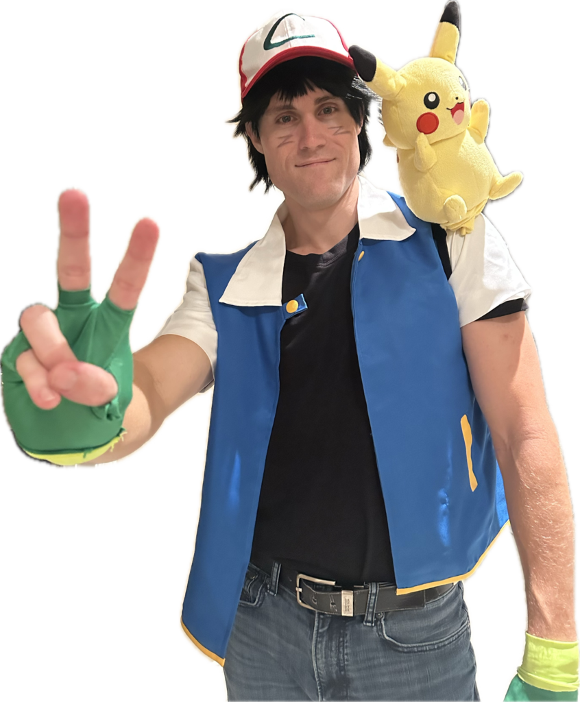  Dad in an Ash Ketchum costume from the Pokémon Family Costumes collection, complete with a red and white cap, blue vest, and a Pikachu plush on his shoulder.